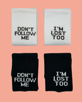 two pairs of dont follow me i am lost too written white and black socks