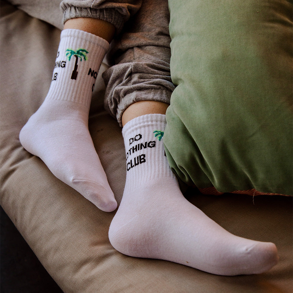 A model wearing white do nothing club socks