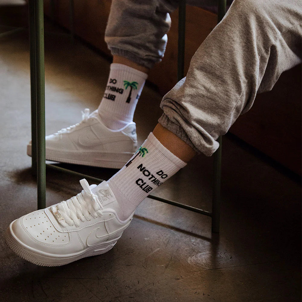 A model wearing do nothing club socks