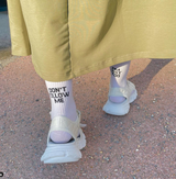 A model wearing white slogan socks