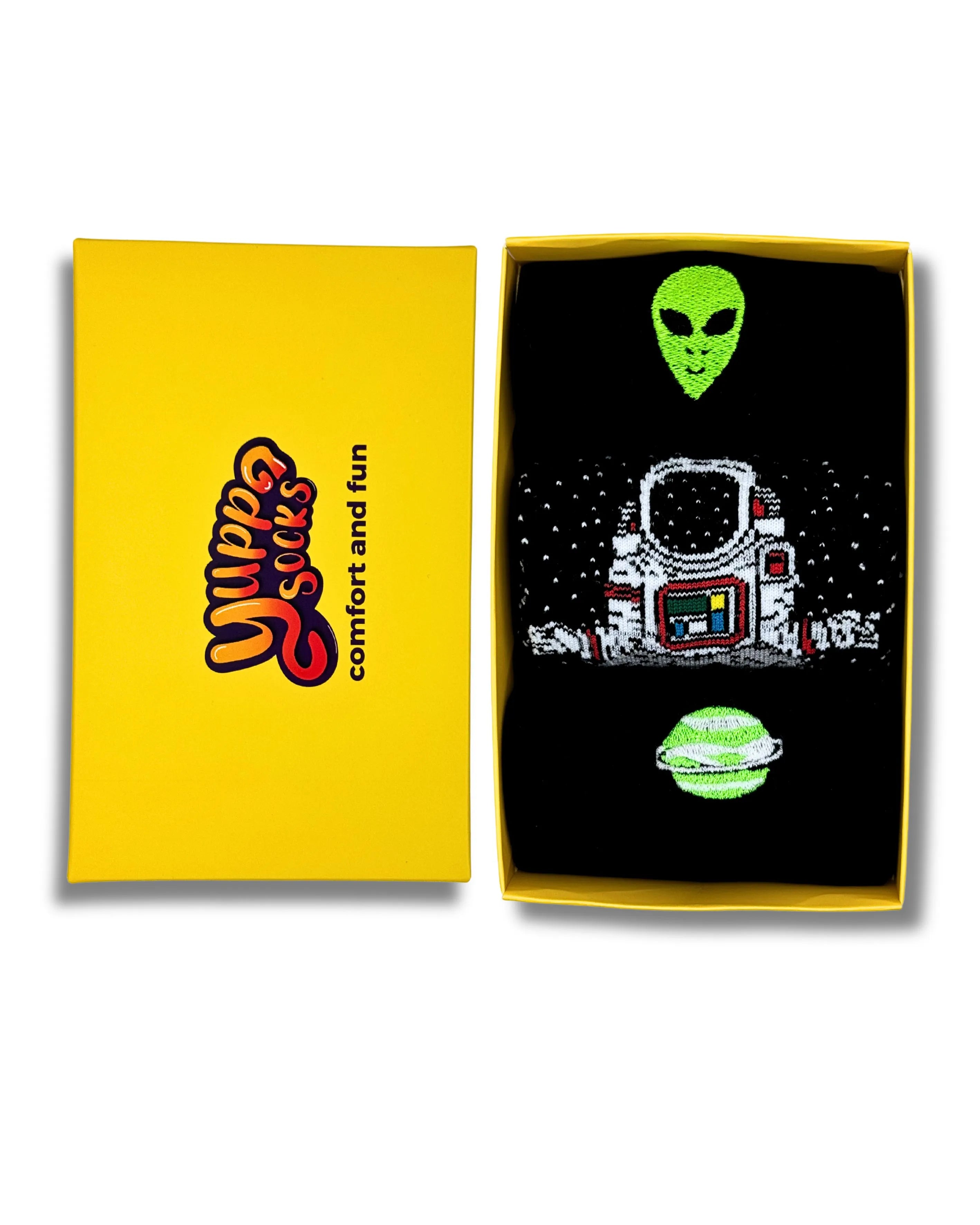 A backs of socks including three black space themed socks including alien, planets and a astronaut