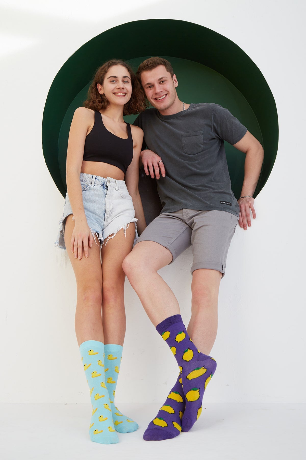 Two models wearing duck socks and lemon socks