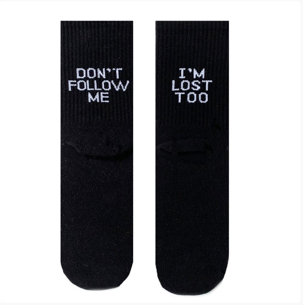 A black pair of dont follow me i am lost too socks